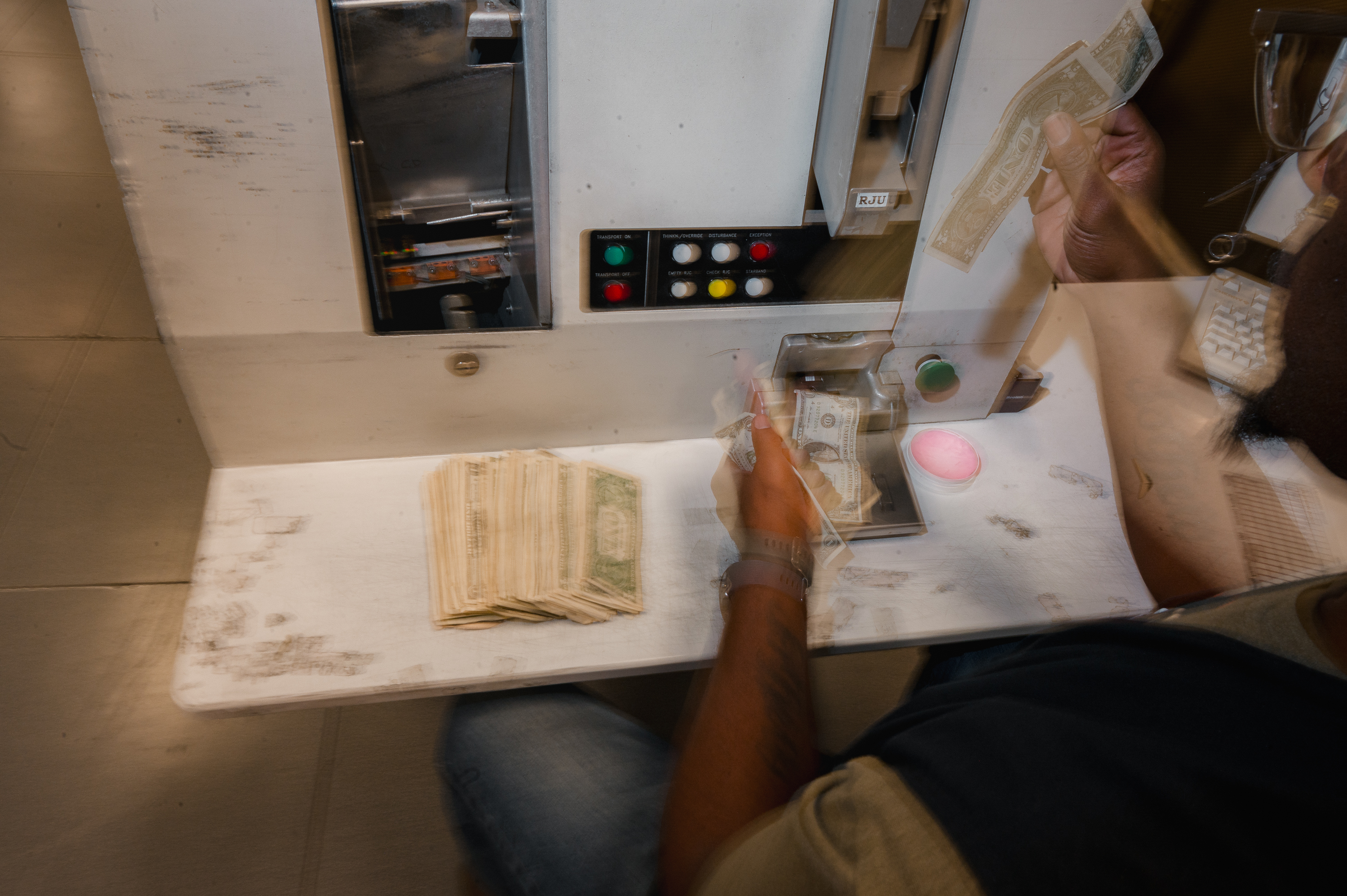 BALTIMORE, MD - JULY 12, 2023:  An employee works at the reconciliation station to manually process currency at the Federal Reserve Bank of Richmond in Baltimore, MD. on Wednesday, July 12, 2023. Fit currency is any currency the currency processor deems as adequate to put back into the public. (Photo by Hannah Yoon for The Washington Post)